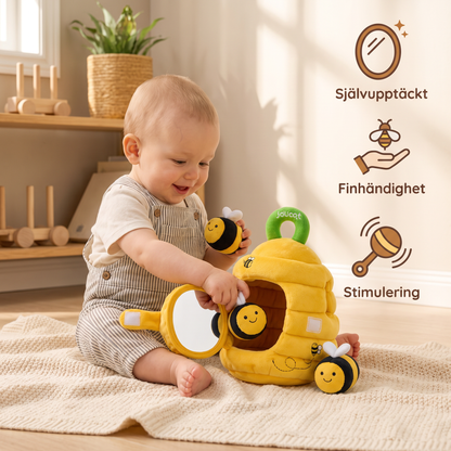 Sensorisk leksak i form av en liten bikupa med skramlande bin, pip och spegel
